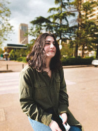 Portrait of beautiful young woman in city