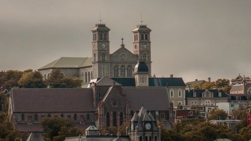 Clock tower in town against sky