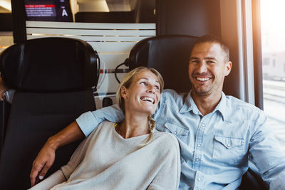 Happy couple enjoying journey in train