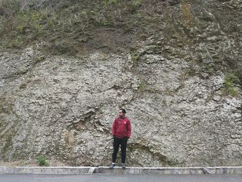 Rear view of woman standing on rock