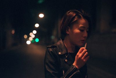 Woman standing at night