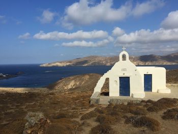 Building by sea against sky