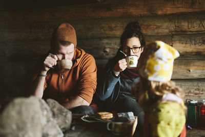 Couple resting with hot drinks