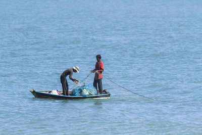 Men fishing in sea