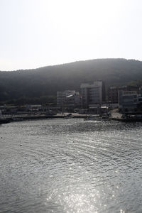 Buildings in city against clear sky