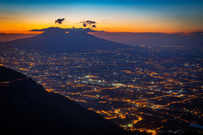 Aerial view of city against sky during sunset