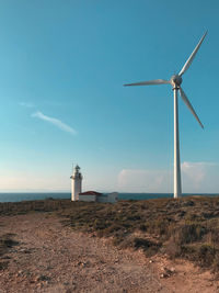 Windmill on field against sky