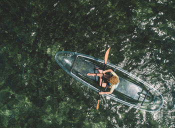 Man in boat against trees