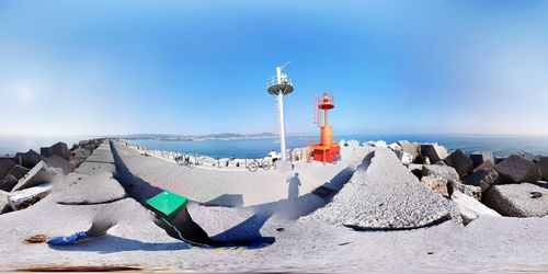 Panoramic view of lighthouse on beach against sky