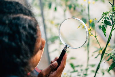 Close-up of boy holding magnifying glass