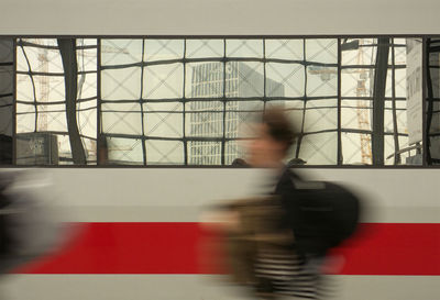 Blurred motion of woman standing on wall