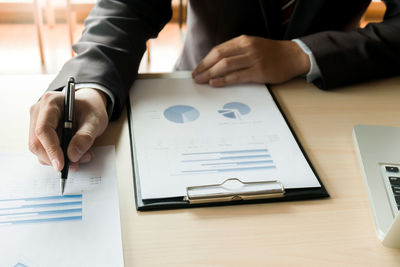 High angle view of man using mobile phone on table