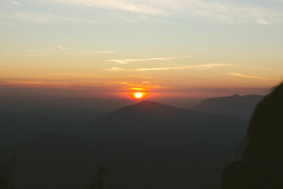 Scenic view of silhouette mountains against sky during sunset