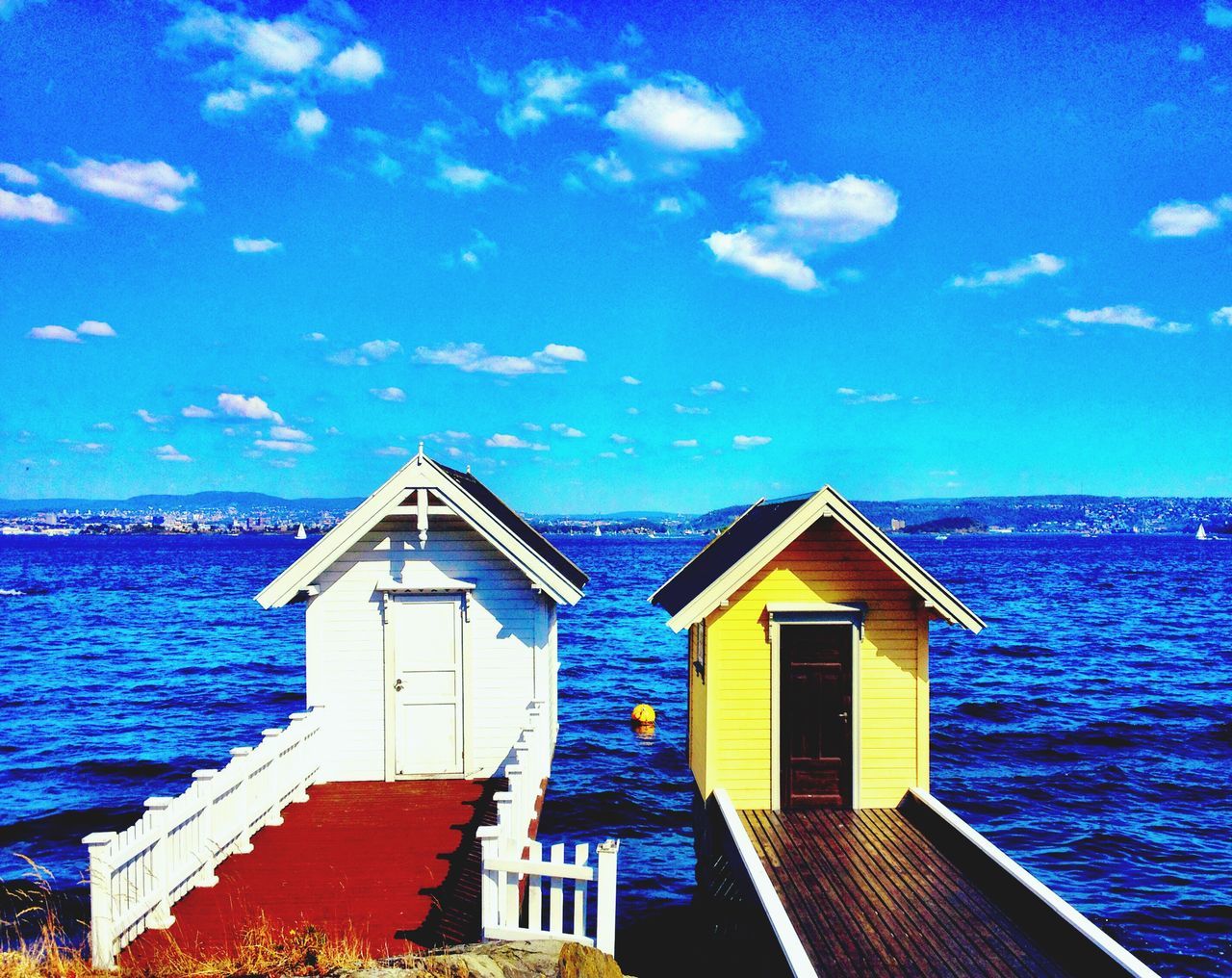 blue, architecture, built structure, building exterior, water, sea, sky, house, turquoise colored, scenics, residential structure, cloud, cloud - sky, nature, beauty in nature, tranquility, tranquil scene, outdoors, day, idyllic