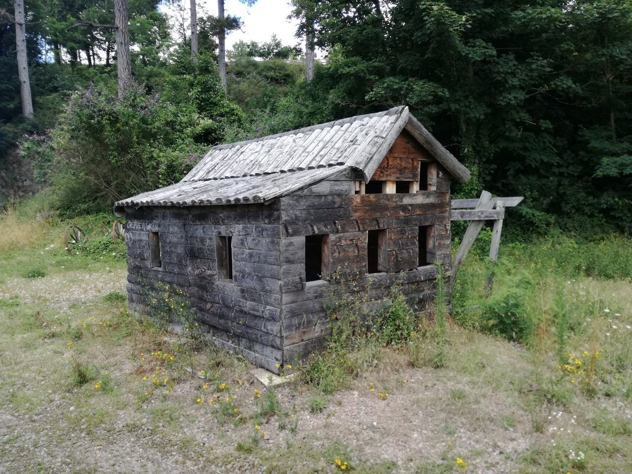 ABANDONED BUILDING IN FIELD