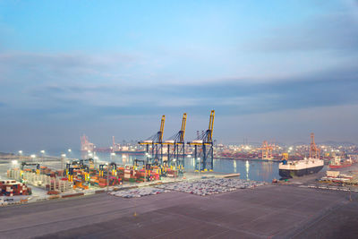 Commercial dock by sea against sky