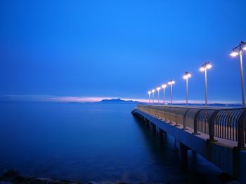 Scenic view of sea against blue sky at night