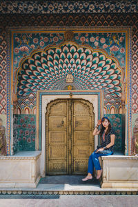 Full length of woman sitting in temple