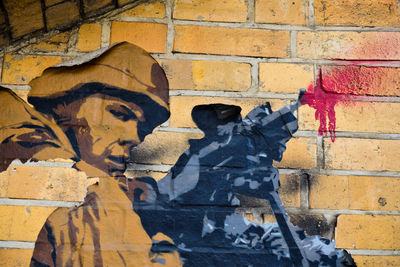 Close-up of graffiti on brick wall