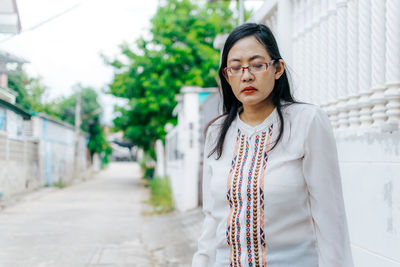 Portrait of young woman standing outdoors