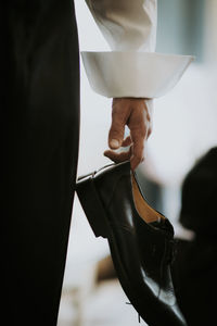 Close-up of hand holding shoe