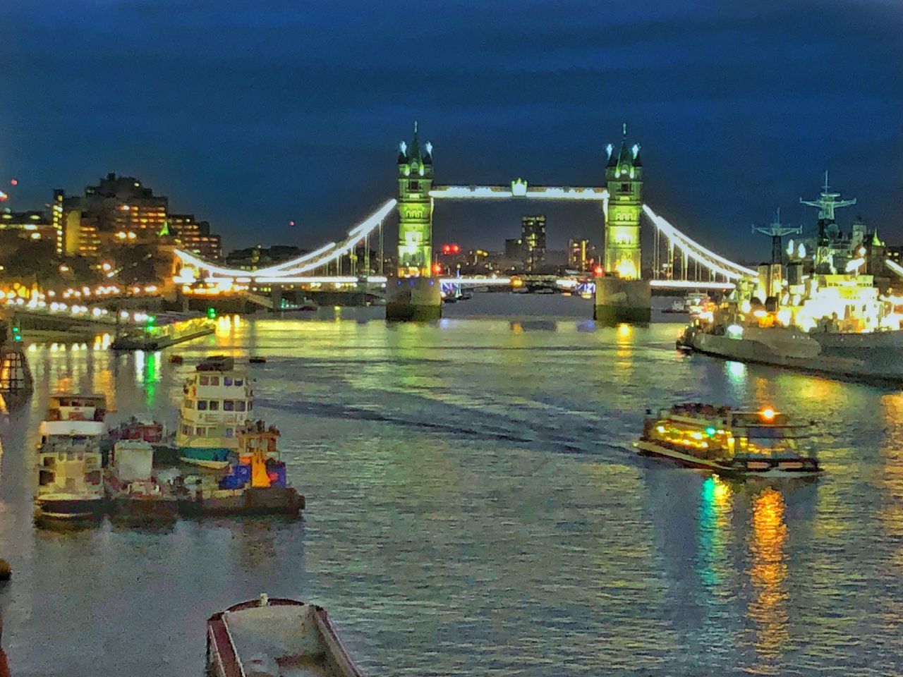 ILLUMINATED BRIDGE OVER RIVER