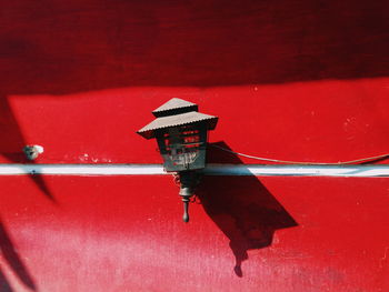 Red boat moored in water