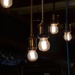 Low angle view of illuminated light bulb hanging
