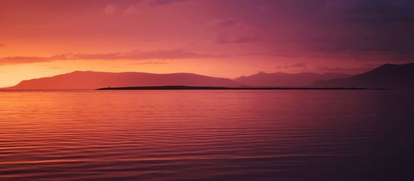 Scenic view of sea against romantic sky at sunset