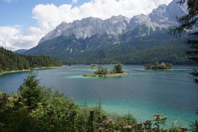 Scenic view of lake and mountains against sky