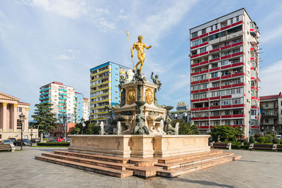 Statue of buildings against cloudy sky