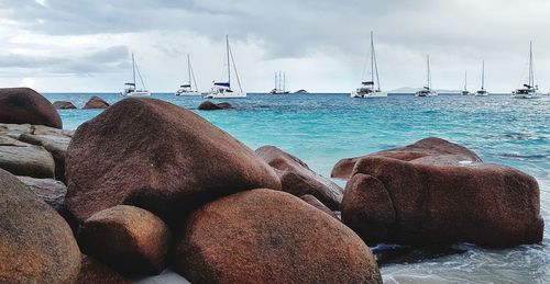 Panoramic view of rocks on beach against sky