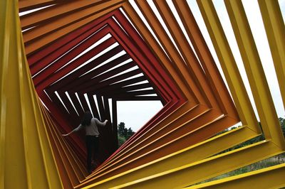 Rear view of woman walking in metallic structure