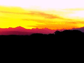 Scenic view of silhouette mountains against sky during sunset