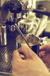 Close-up of hand holding coffee cup