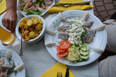 Sea food with salad and prepared potatoes served on table