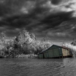 Scenic view of lake against storm clouds