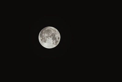 Low angle view of full moon at night