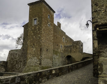 Low angle view of historic building against cloudy sky