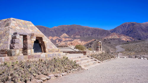 Scenic view of mountains against blue sky