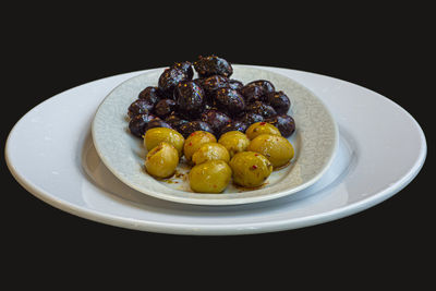 Close-up of fruits in plate on table