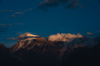 Panoramic view of snowcapped mountains against sky during sunset