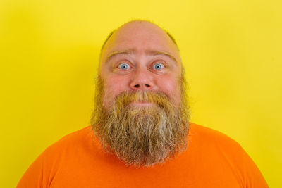 Portrait of young man against yellow background