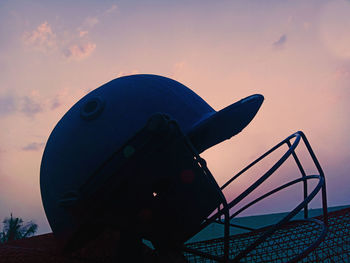 Close-up of silhouette railing against sky during sunset