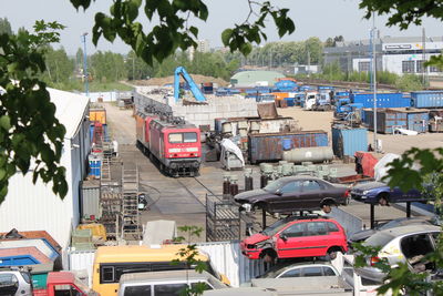 Cars on road against sky in city