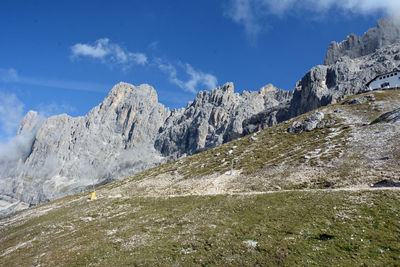 Scenic view of mountains against blue sky