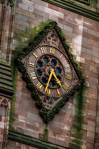 Low angle view of clock tower against building