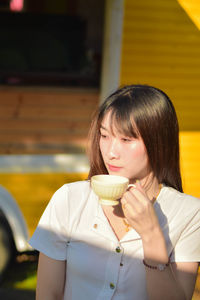 Portrait of smiling young woman looking away