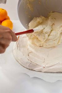 Close-up of hand holding ice cream in bowl