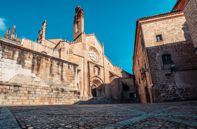 Low angle view of old building against blue sky